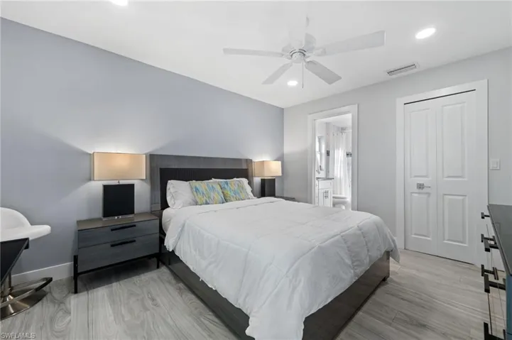 Beautiful Primary Bedroom with light wood-style flooring, recessed lighting, ensuite bath, and ceiling fan