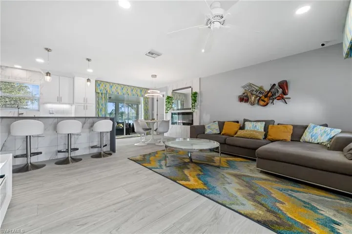 Living room featuring ceiling fan, recessed lighting, and light wood-style flooring