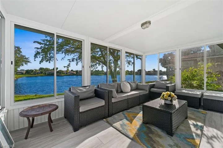 Sunroom featuring an outdoor hangout area and a water view