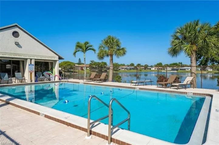 Community pool with a patio area and a water view