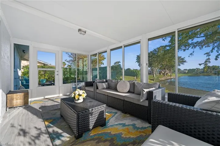 Sunroom / solarium featuring an outdoor hangout area, a water view, and french doors