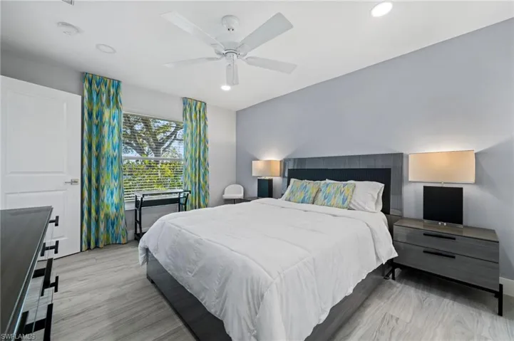 Bedroom featuring ceiling fan, light wood-type flooring, and recessed lighting