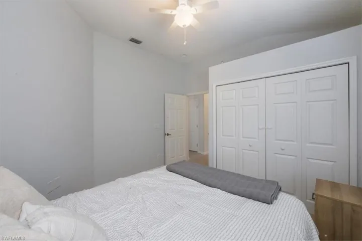 Bedroom with a ceiling fan, a closet, and carpet
