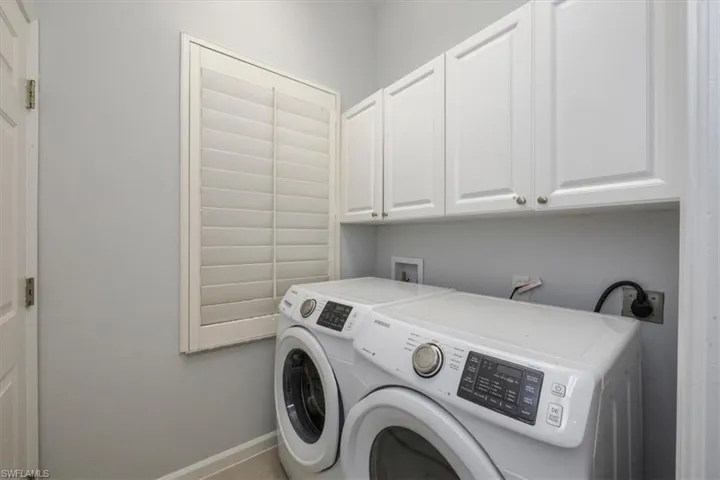 Laundry area featuring cabinet space and washing machine and dryer