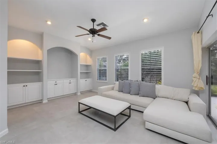 Living room featuring built in features, ceiling fan, and recessed lighting