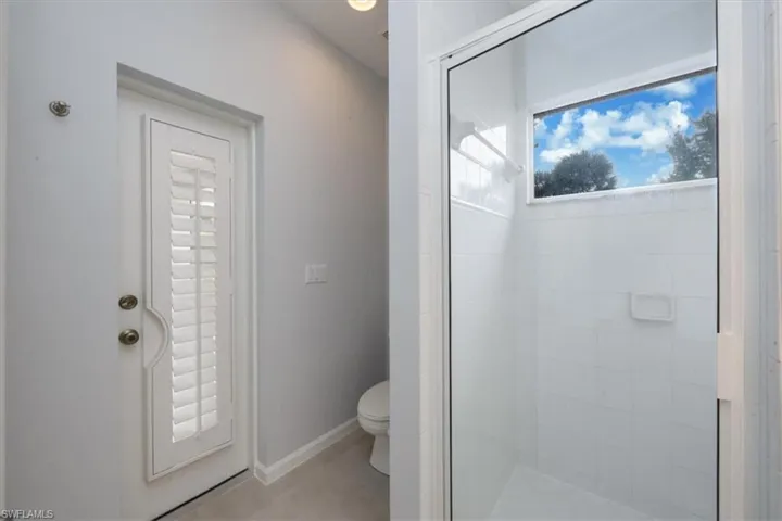 Full bathroom with a stall shower and toilet