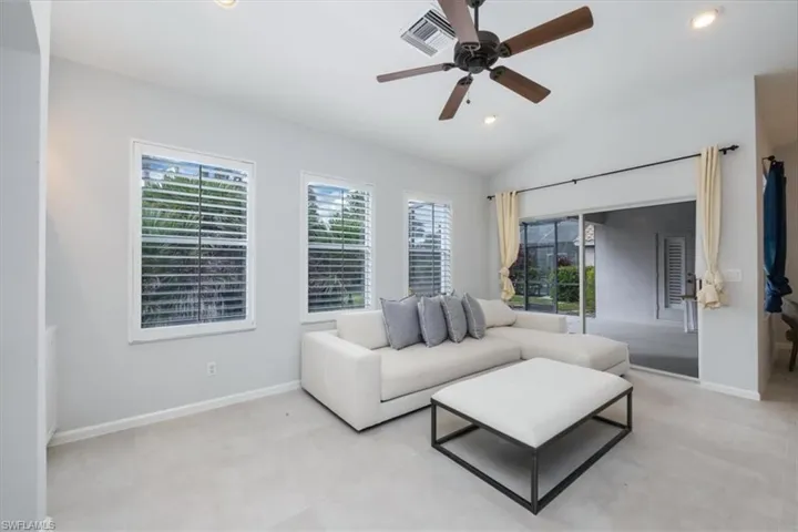 Living area featuring vaulted ceiling, recessed lighting, and a ceiling fan