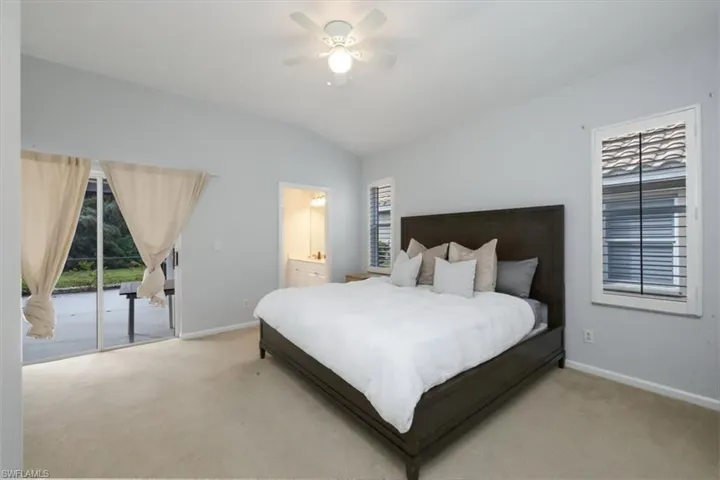 Bedroom with lofted ceiling, access to outside, carpet flooring, and ceiling fan
