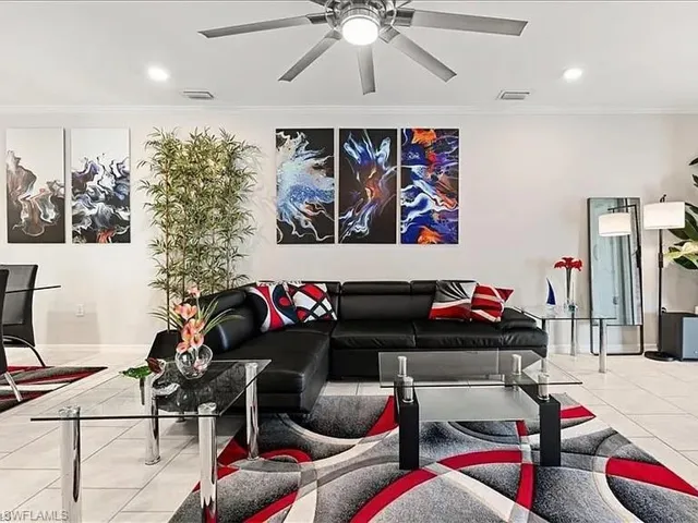 Tiled living room featuring crown molding, recessed lighting, and a ceiling fan