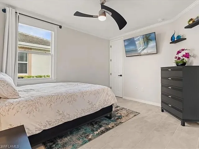 Bedroom featuring crown molding and ceiling fan