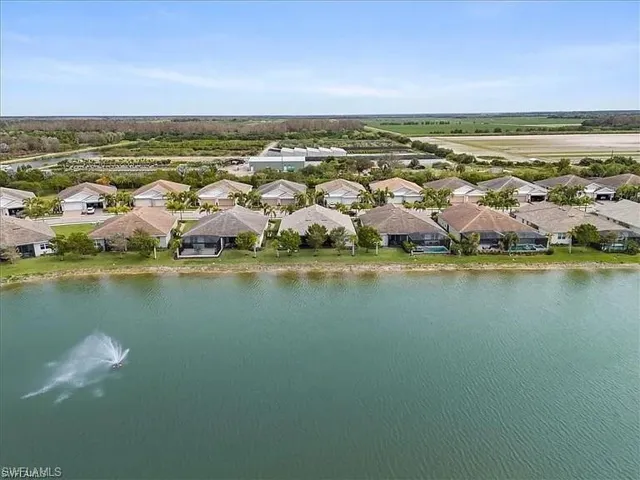 Aerial view of residential area featuring a nearby body of water