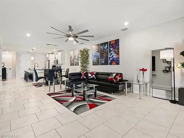 Living room with recessed lighting, light tile patterned floors, and a ceiling fan