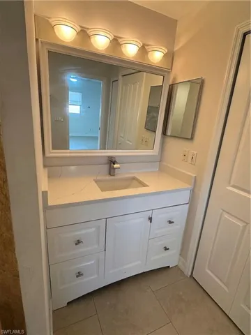 Bathroom with vanity and light tile patterned floors