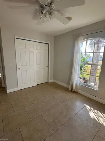 Unfurnished bedroom featuring a closet and ceiling fan