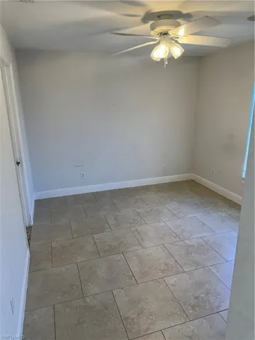 Spare room featuring baseboards and a ceiling fan