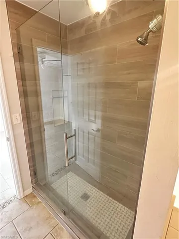 Full bath featuring a stall shower and tile patterned floors