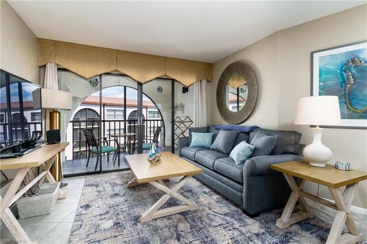 Relax on the couch and watch the flat screen TV.