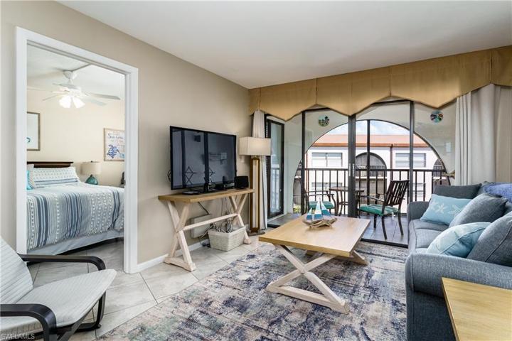 View of the living room, balcony and bedroom.