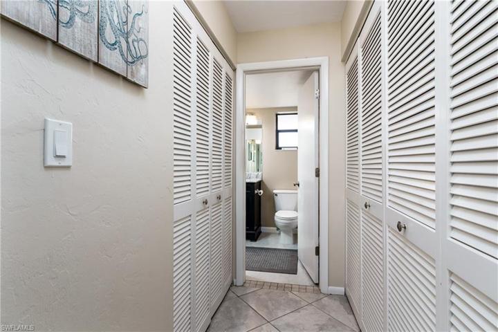 Hallway with closets leading to the bathroom.