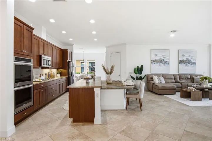 The OPEN kitchen floor plan feels modern yet delivers functionality for a chef and larger entertaining. Custom leathered, exotic countertops are a showstopper!