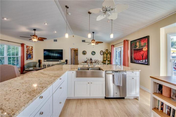 Kitchen showing stainless farmhouse sink and granite countertops