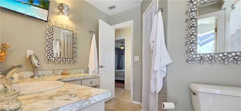 Dual vanity featuring undermount sinks and marbled countertops