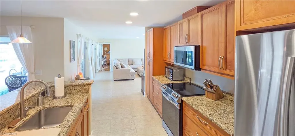 Kitchen featuring light wood cabinetry and granite countertops