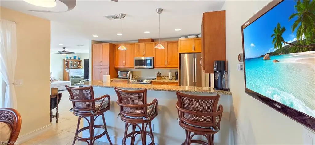 Kitchen featuring wood cabinetry, stainless steel appliances, and a light-toned countertop