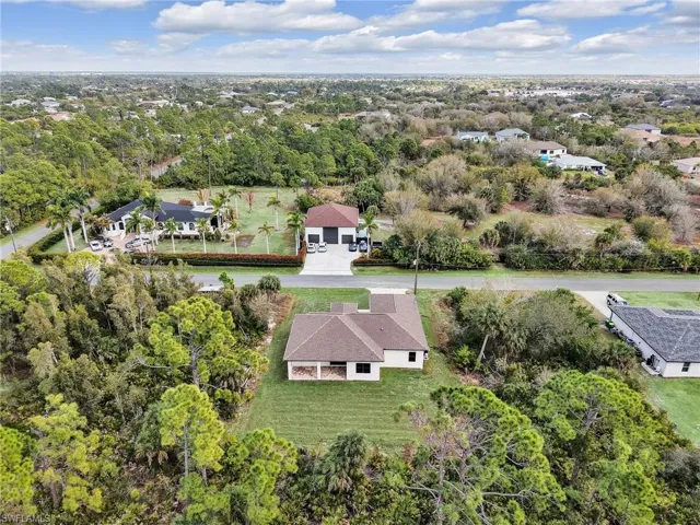 Aerial view of residential area featuring a tree filled landscape
