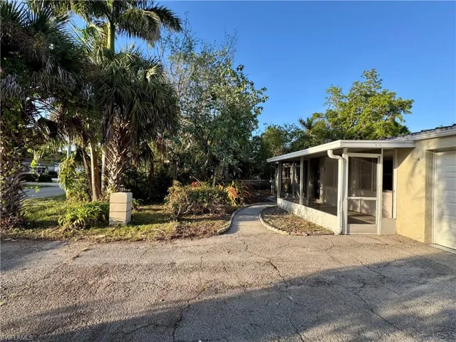 View of property exterior featuring a screened porch