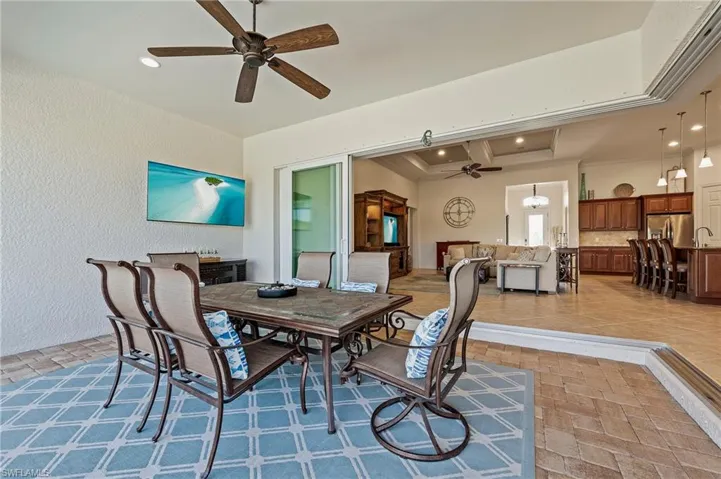 Dining area featuring ceiling fan, light tile patterned floors, and crown molding