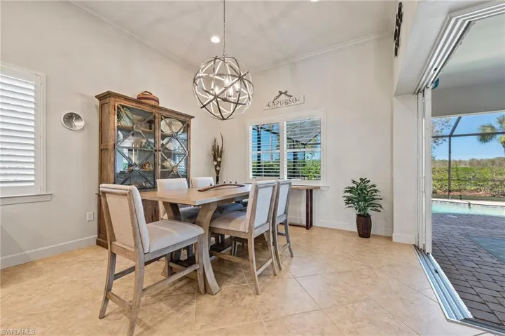 Dining room with plenty of natural light, ornamental molding, and light tile patterned flooring