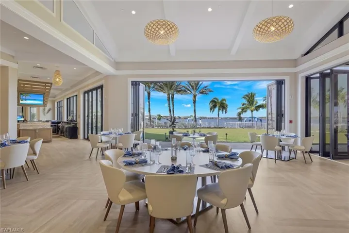 Dining area featuring beam ceiling, high vaulted ceiling, and a healthy amount of sunlight
