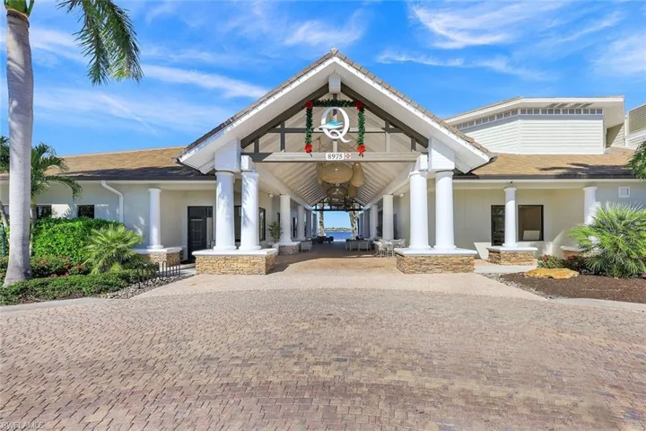Kitchen featuring hanging light fixtures, stainless steel double oven, an inviting chandelier, crown molding, and an island with sink