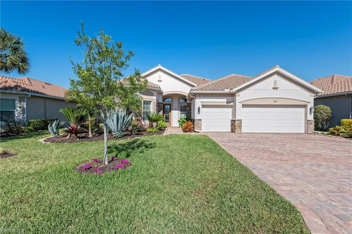 Mediterranean / spanish home with a front yard and a garage