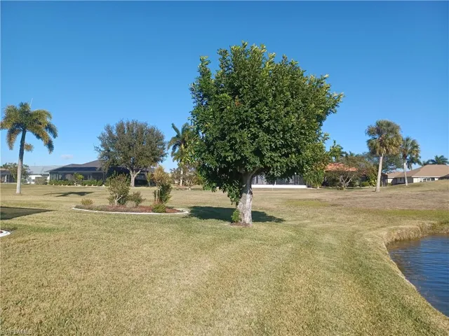View of green lawn featuring a water view