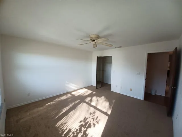 Unfurnished bedroom with carpet flooring and ceiling fan