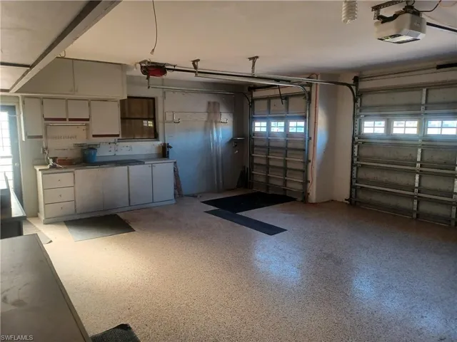 Garage featuring a garage door opener