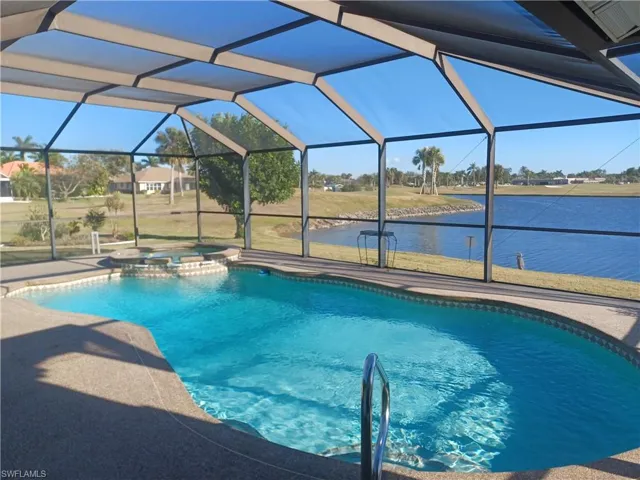 Integrated pool / spa with a sunroom, a lanai, and a water view