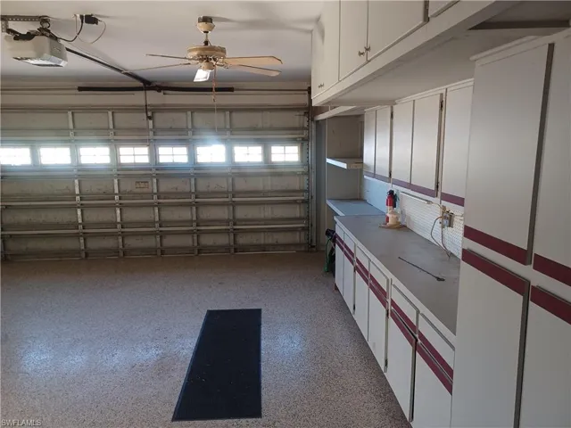 Garage with a ceiling fan and a garage door opener