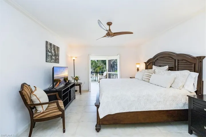 Bedroom with ceiling fan, access to exterior, and ornamental molding