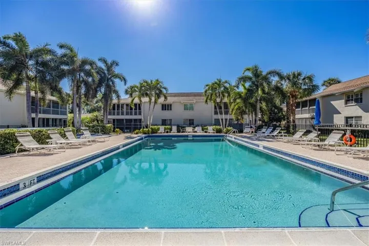 Pool with a patio and fence