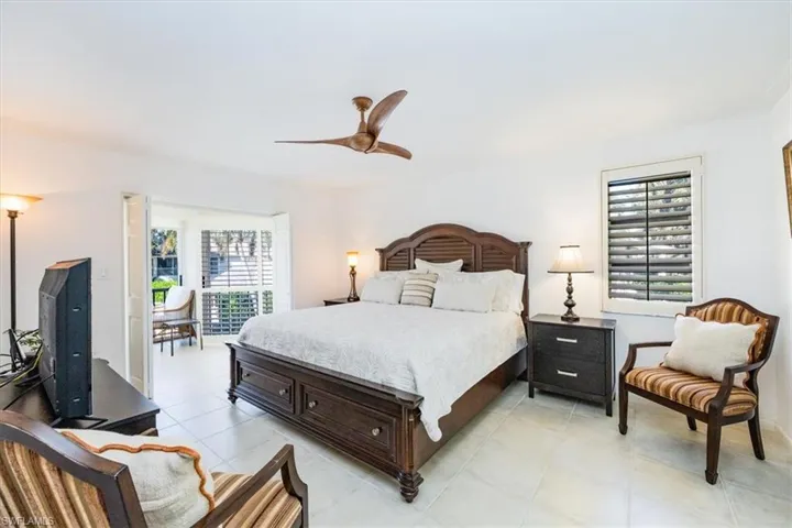 Bedroom with light tile patterned floors and ceiling fan