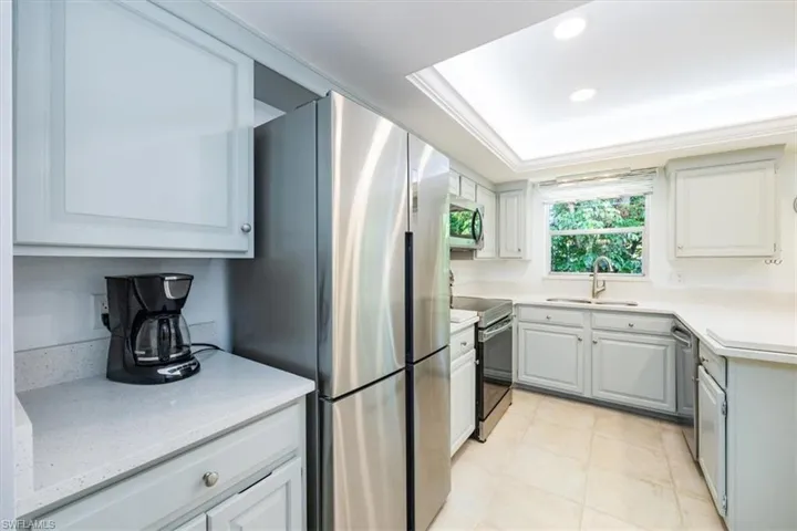 Kitchen featuring recessed lighting, stainless steel appliances, ornamental molding, and a sink