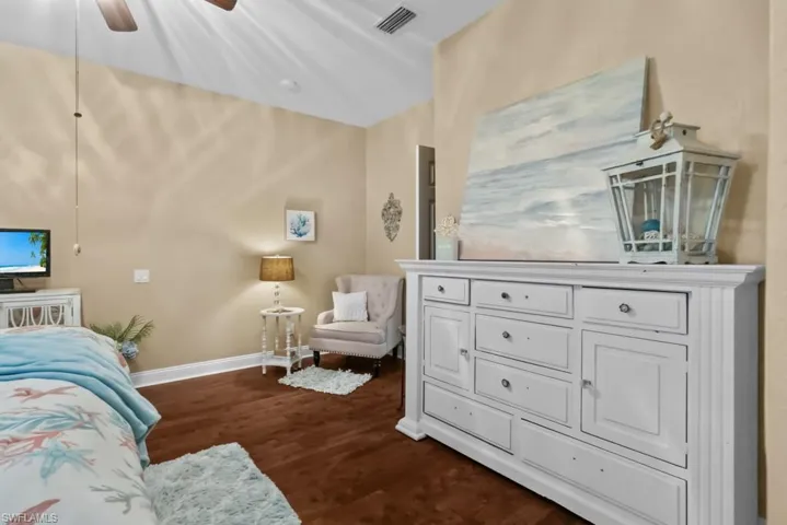 This room features rich wood flooring and a ceiling fan, offering both style and comfort