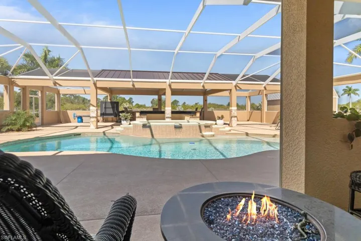 The property features a screened-in lanai with a swimming pool and an integrated spa