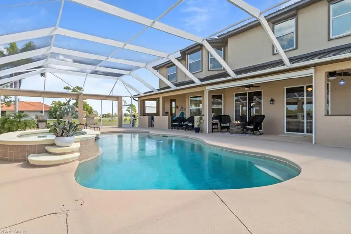 The property features a screened-in swimming pool and a built-in spa