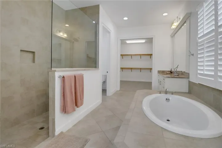 Bathroom featuring vanity, separate shower and tub, and tile patterned flooring