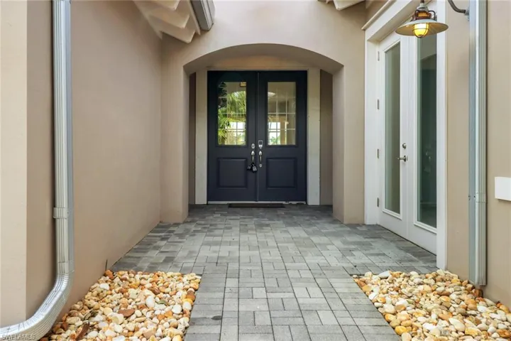 Property entrance featuring french doors