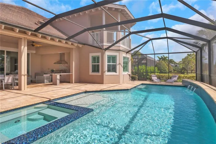 View of pool with an in ground hot tub, ceiling fan, a patio, and a lanai